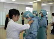 Students are putting on PPE.