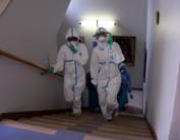 They go up the stairs with putting on PPE.